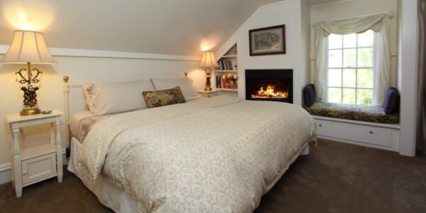 cambria bed and breakfast guest room with bed and fireplace