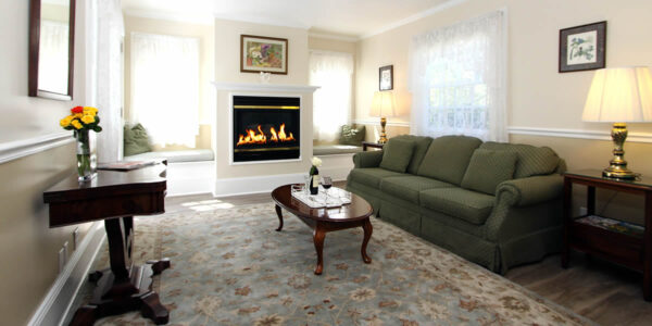 cambria bed and breakfast guest room with couch and fireplace