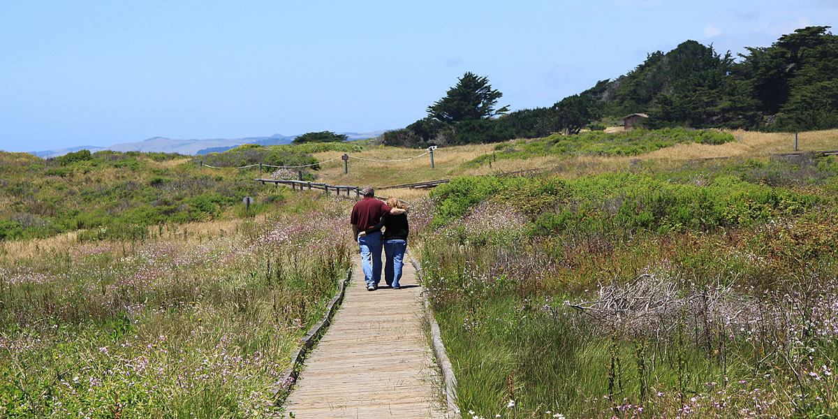 couple walks at moonstone beach