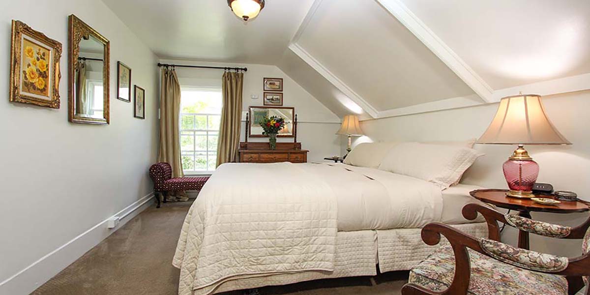 cambria bed and breakfast guest room with bed and chair